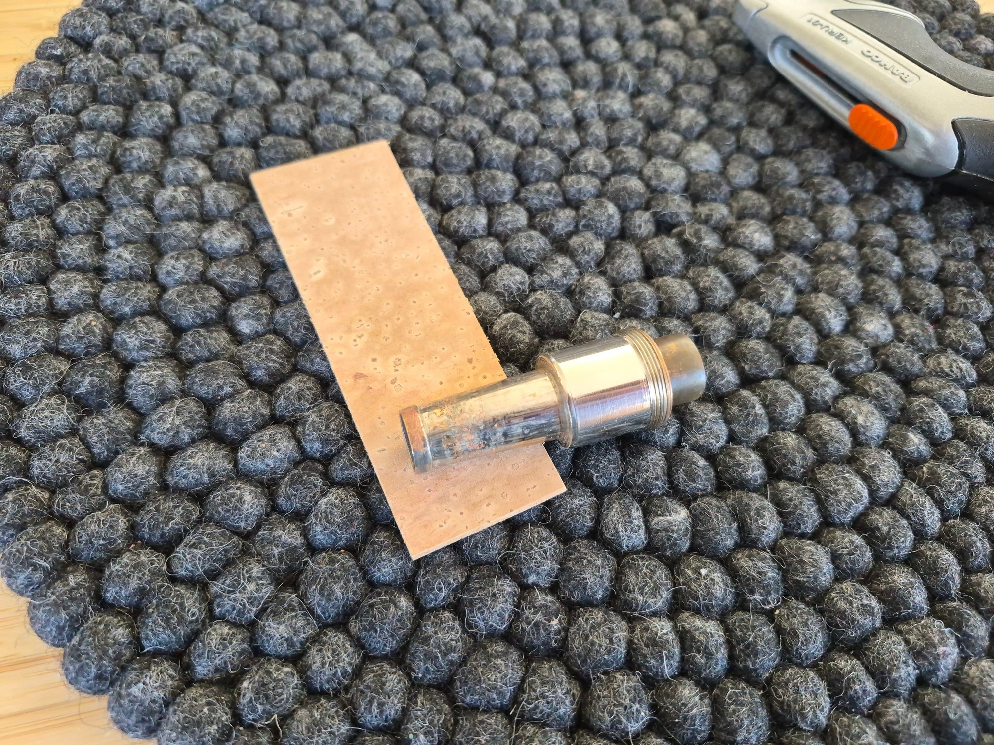 The cleaned neckpipe on top of the rectangular cork piece.
