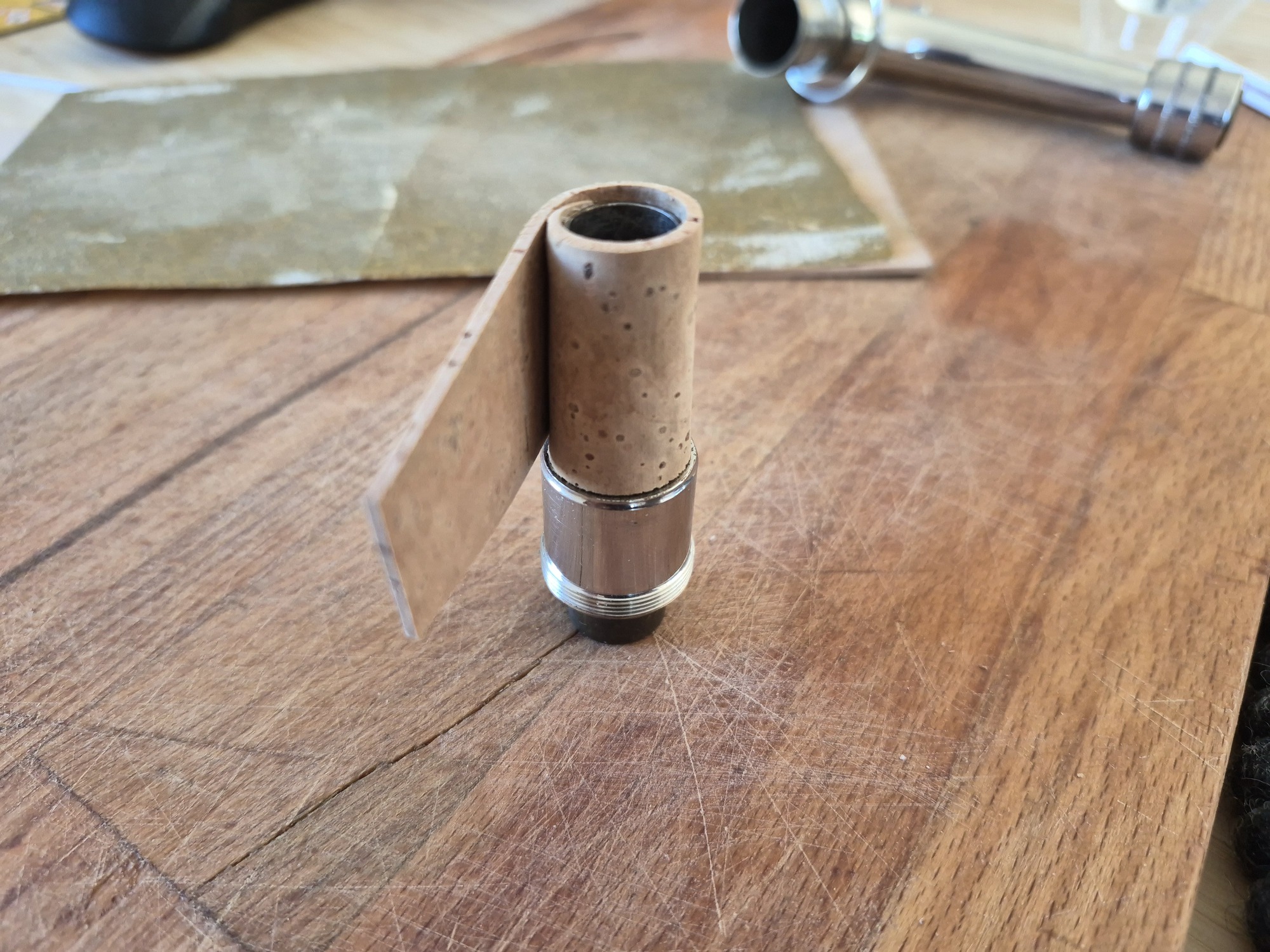 The cork wrapped around the neckpipe with the excess visible.