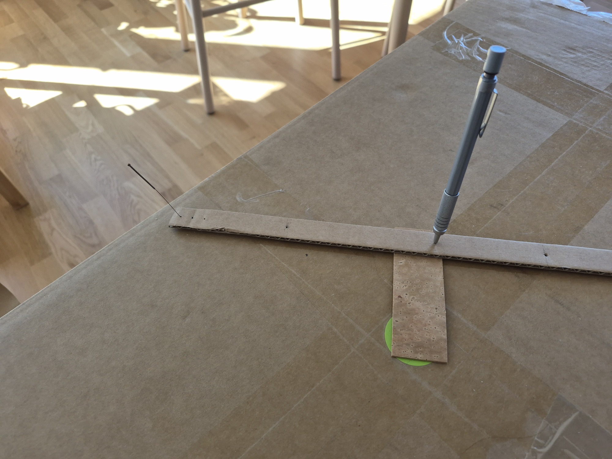 The improvised compass used to draw the arc on the cork.
