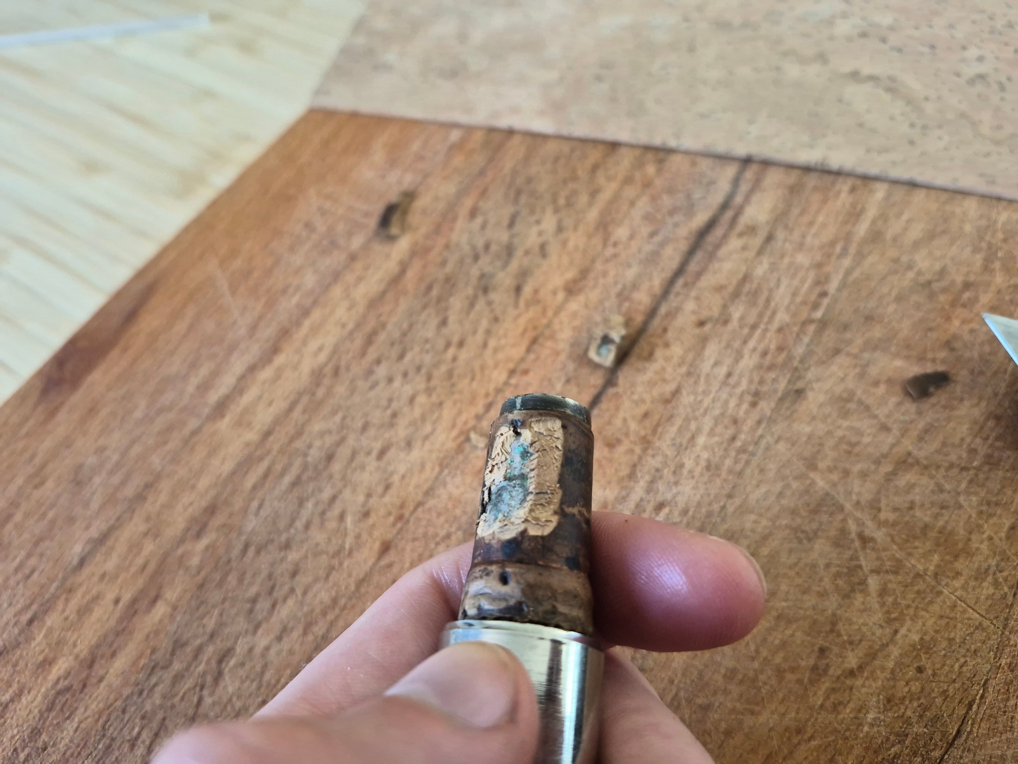 Verdigris under the old cork of the neckpipe.